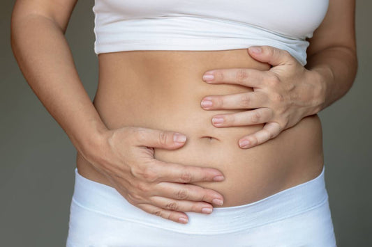 Woman holding bloated stomach
