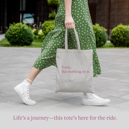 person in green dress walking outside with tote bag