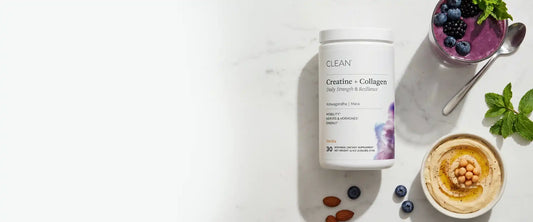 Iclean Creatine + Collagen supplement container on a white surface with a bowl of hummus and berries.