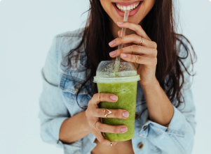 Woman enjoying a greens smoothie
