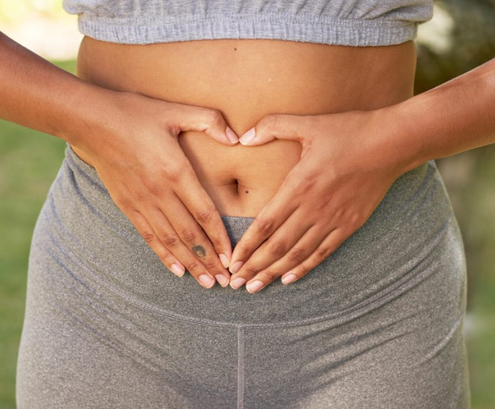 Woman holding hands over her stomach