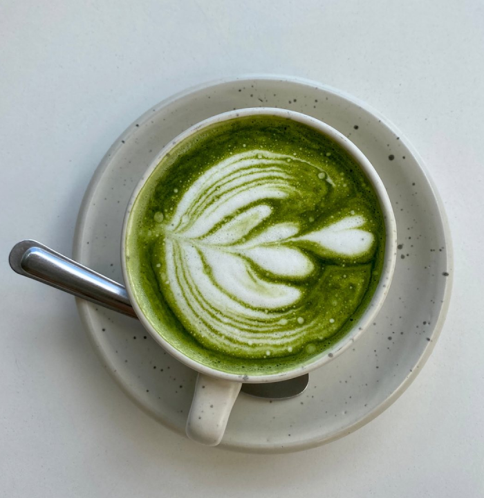 Matcha latte with leaf design.