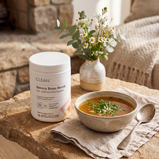 Savory Bone Broth jar and soup bowl on rustic stone with flowers. Savory Bone Broth jar and soup bowl on rustic stone with flowers.