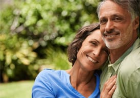 Couple outside leaning into each other
