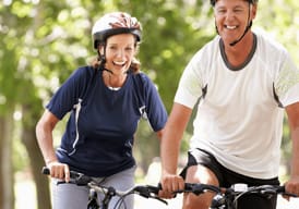 Couple happily bicycling together