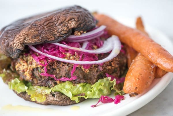 Black Bean Burger on a plate with cooked carrots