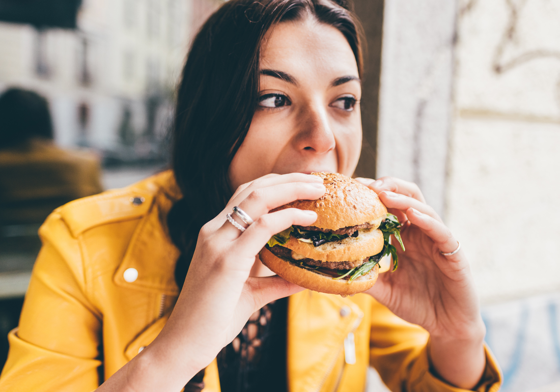 women eating hamburger