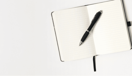 empty notebook with pen on it