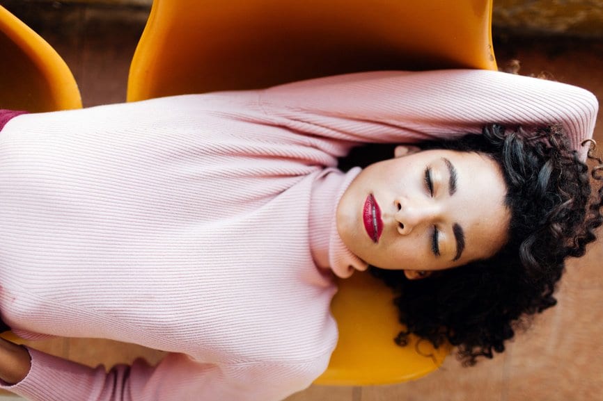 Woman laying down across chairs