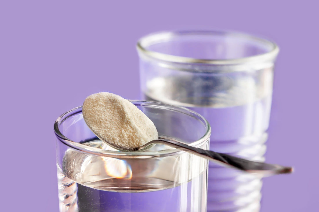 spoon with powder over glass of water