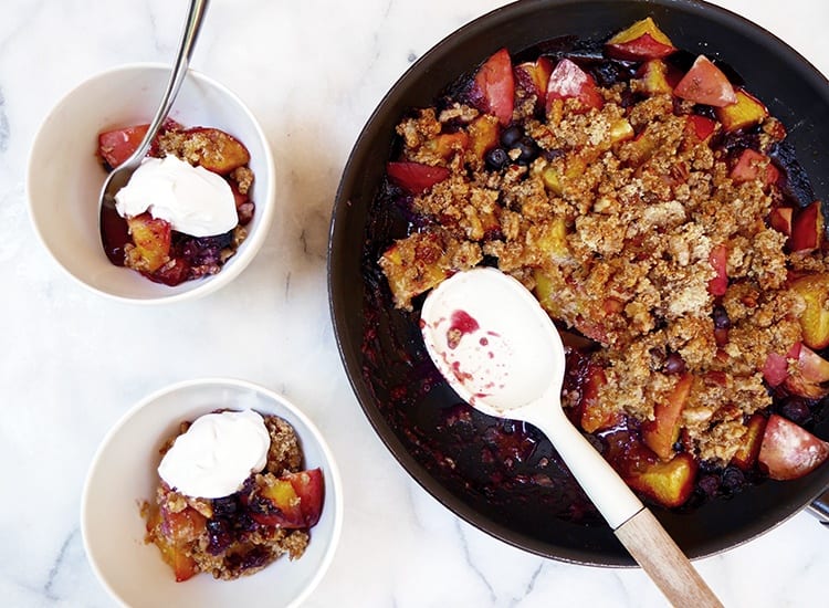 Peach cobbler in a bowl with a spoon
