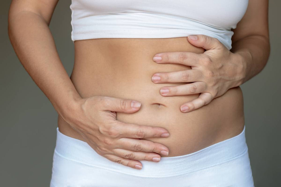 Woman holding bloated stomach