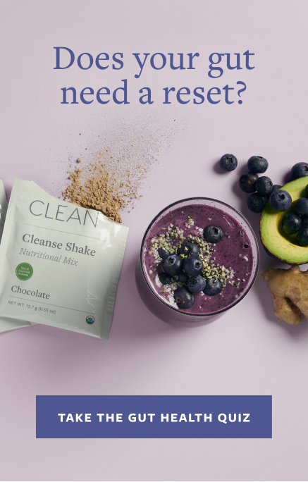 Purple smoothie with blueberries and a 'Clean' shake mix on a light purple background