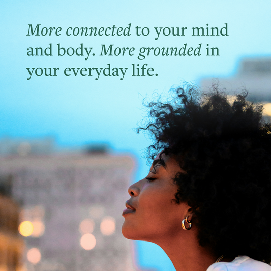 Woman's side profile against a city background with the text: "More connected to your mind and body. More grounded in your everyday life."