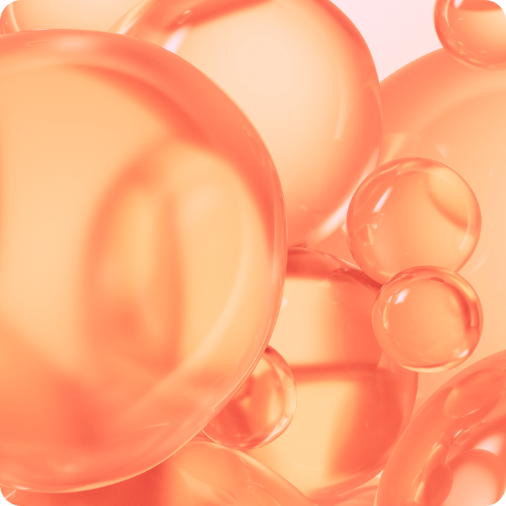 Close-up of orange bubbles on a light pink background