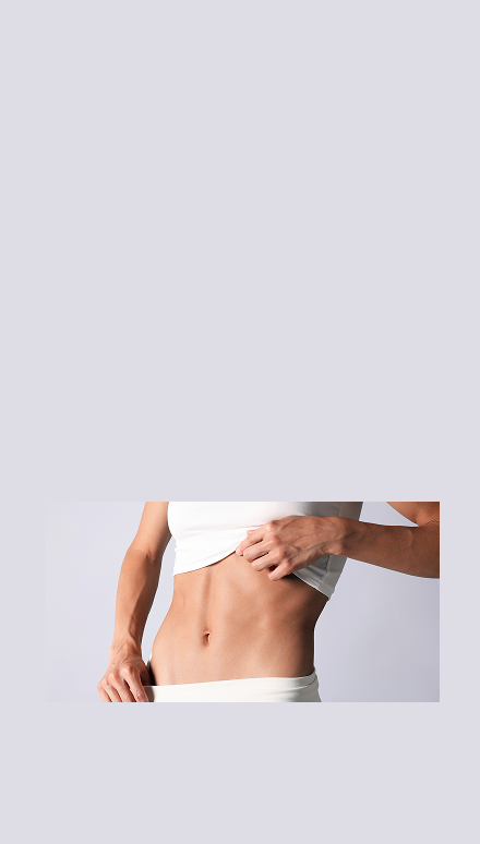 A cropped studio photo of a woman's midsection showing a white sports bra and white underwear against a light gray background.
