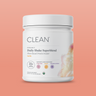 Container of Clean Daily Shake Superblend protein powder on a peach background