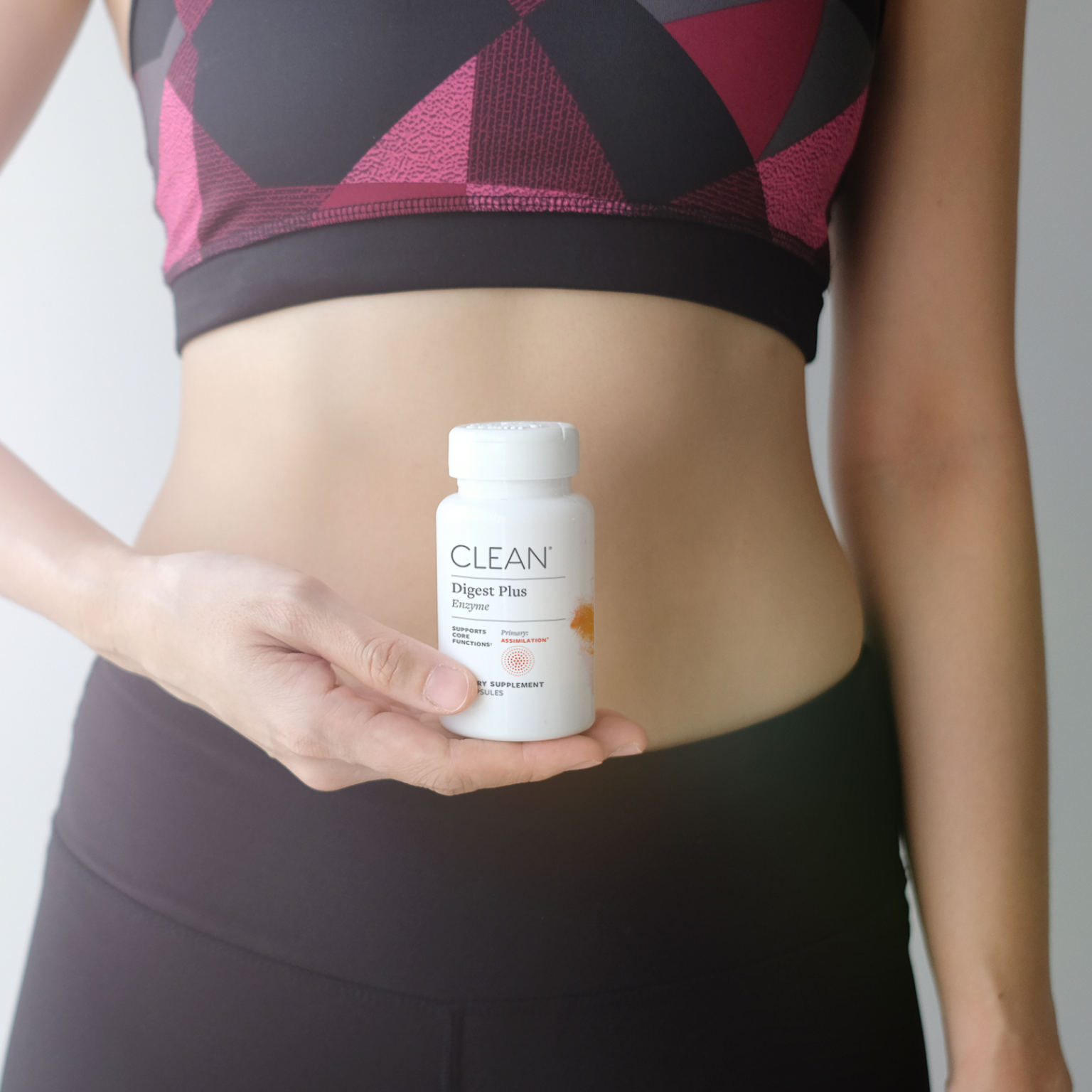 Jump to Person holding a digest plus supplement bottle labeled 'CLEAN' against a neutral background in product gallery