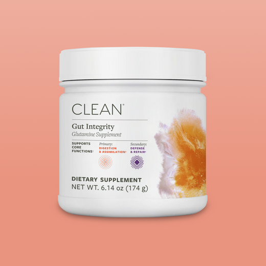 Supplement container labeled 'Clean Gut Integrity' on a peach background