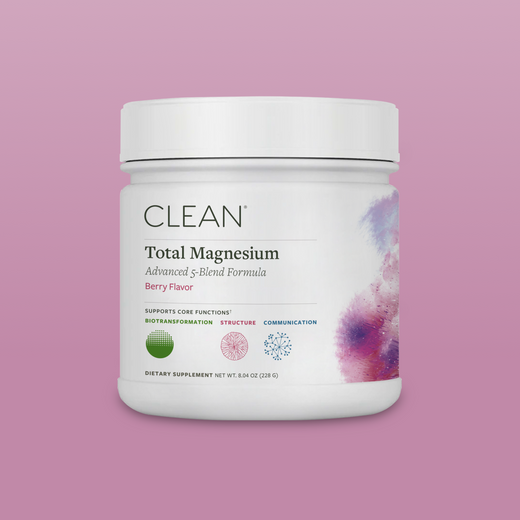 Container of CLEAN Total Magnesium supplement on a pink background