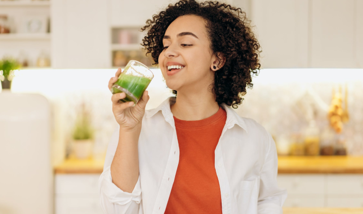 Woman drinking all-natural greens smoothie