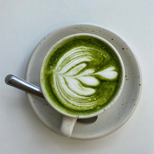 Matcha latte with leaf design.